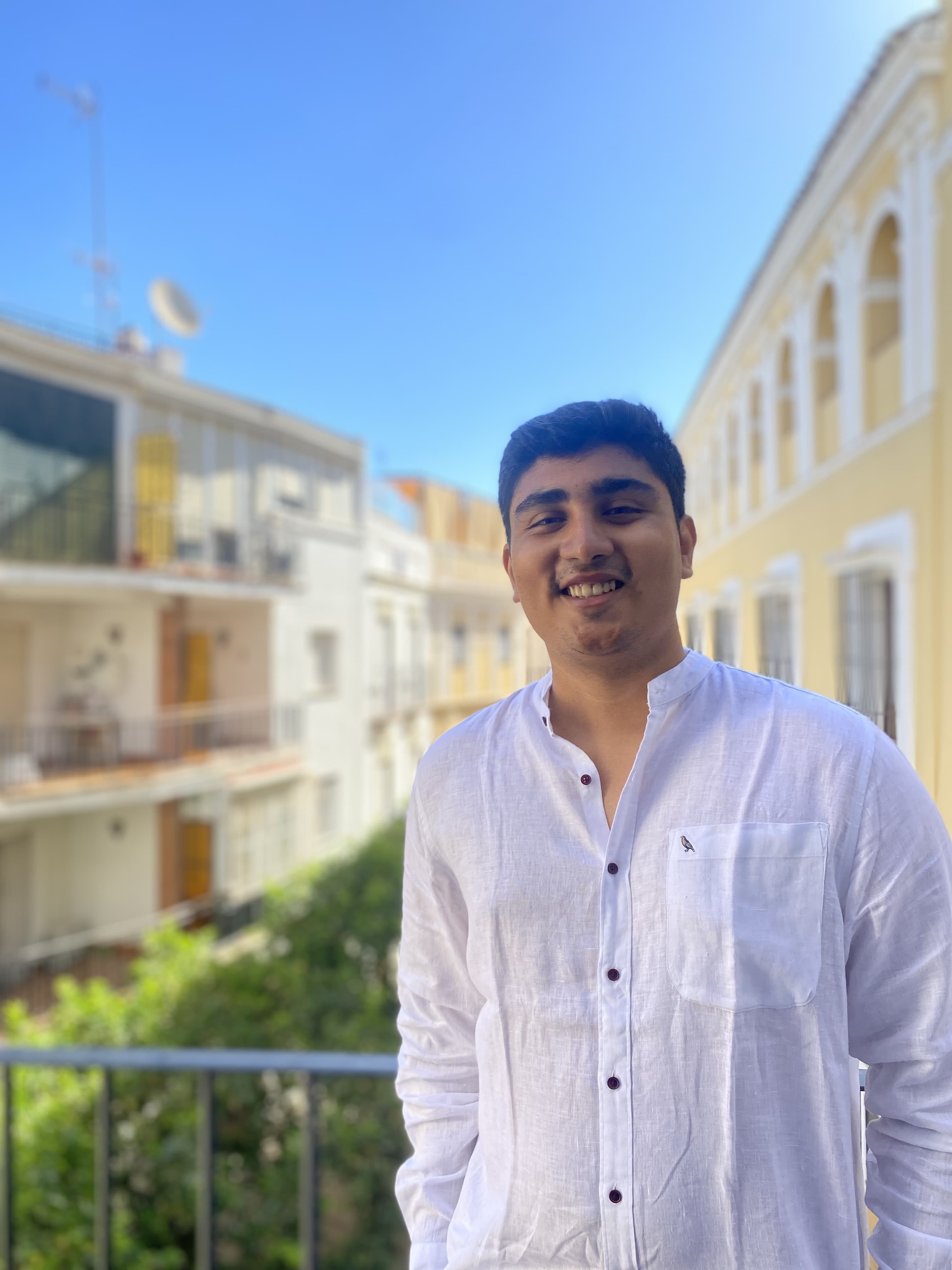 Nishant Desai smiling on a balcony